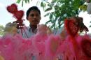 A Cambodian man buys Valentine's gifts along a street in Phnom Penh on February 14, 2012