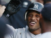 New York Yankees' Robinson Cano smiles as he celebrates with teammates after hitting a three-run home run during the first inning of a baseball game against the Chicago White Sox in Chicago, Wednesday, Aug. 3, 2011. (AP Photo/Nam Y. Huh)