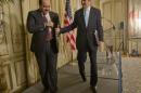 US Secretary of State John Kerry, right, walks off stage with Qatar's Foreign Minister Khalid al-Attiyah, left, following the conclusion of their news conference at the US Ambassador's residence in Paris, France, Sunday, Jan. 12, 2014. Kerry is in Paris to attend a two-day meeting on Syria to rally international support for ending the three-year civil war in Syria. (AP Photo/Pablo Martinez Monsivais, Pool)