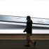 A man walks past an iPad2 advertisement in Shanghai, China, Monday Feb. 13, 2012. A Chinese company said Tuesday it will ask customs officials to ban imports and exports of Apple Inc.'s iPads due to a dispute over ownership of the trademark. (AP Photo)  CHINA OUT