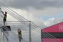 Construction workers are seen at Riverbank Stadium in Olympic Park in Stratford