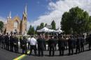 Emergency responders form an honor guard prior to a memorial mass at the Sainte-Agnes church in Lac-Megantic