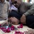 A man comforts a woman who cries over a coffin of her family member who was killed in Friday's passenger plane crash, at a local hospital in Islamabad, Pakistan on Saturday, April 21, 2012. Pakistan blocked the head of an airline whose jet crashed near the capital from leaving the country as it began an investigation Saturday into the country's second major air disaster in less then two years. (AP Photo/B.K. Bangash)