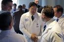 Dr. Dicken Ko, director of Massachusetts General Hospital's urology program, shakes hands with surgical team members after a news conference at the hospital, Monday, May 16, 2016, in Boston to announce the first penis transplant in the United States. Cancer patient Thomas Manning, of Halifax, Mass., received a transplanted penis in a 15-hour procedure last week. The organ was transplanted from a deceased donor. (AP Photo/Elise Amendola)