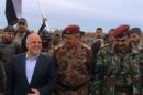 A handout image released by the press office of Iraqi Prime Minister Haider al-Abadi on December 29, 2015 shows him (L) walking with Lieutenant-General Abdel Ghani al-Assadi (C) in Ramadi