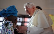 Pope Benedict XVI blesses community members at St. Rita's Parish in Cotonou, Benin. Pope Benedict XVI on Saturday labelled AIDS an "ethical problem" and condemned corruption as he laid out a vision for his Church's future in Africa on his second visit to the continent. (AFP Photo/Vincenzo Pinto)