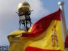 A Spanish flag flutters in the wind in front of the dome of Bank of Spain headquarters in central Madrid