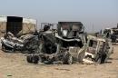 Burned and destroyed Iraq military vehicles on a road in the town of Samarra, on July 12, 2014