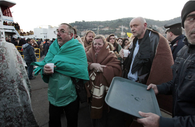 Passengers of the luxury ship that ran aground off the coast of Tuscany arrive on a ferry in Porto Santo Stefano, Italy, Saturday, Jan. 14, 2012. A luxury cruise ship ran aground off the coast of Tusc