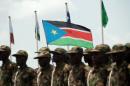 South Sudanese soldiers march with their national flag during a military parade in Juba on July 9, 2011 as part of celebrations marking South Sudan's independence as it became the world's newest nation