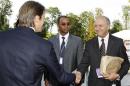 French Finance Minister Baroin shakes hands with socialist party member Fabius at the MEDEF union summer forum in Jouy-en-Josas