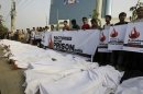 Bangladeshi protesters hold placards as some of them lie down on the ground posing as dead bodies as they condemn the death of workers in a weekend fire at a garment factory in Dhaka, Bangladesh, Wednesday, Nov. 29, 2012. Saturday's fire at Tazreen Fashions Ltd., a factory in a Dhaka suburb, killed 112 people. Activists in the South Asian country hope the tragedy will invigorate their lengthy, but so far fruitless efforts to upgrade safety standards and force stronger government oversight of the powerful industry. (AP Photo/Pavel Rahman)