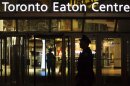 Police stand guard in front of the Toronto Eaton Centre shopping mall where a shooting occurred in Toronto