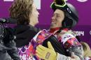 Switzerland's Iouri Podladtchikov, left, celebrates with Shaun White of the United States after Podladtchikov won the gold medal in the men's snowboard halfpipe final at the Rosa Khutor Extreme Park, at the 2014 Winter Olympics, Tuesday, Feb. 11, 2014, in Krasnaya Polyana, Russia. (AP Photo/Andy Wong)