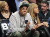 FILE - In this Nov. 26, 2012, file photo, rap mogul and Brooklyn Nets minority owner Jay-Z and his wife, Beyonce, watch an NBA basketball game between the Nets and the New York Knicks at Barclays Center in New York. Jay -Z is selling his stake in the Nets so he can become certified as a player agent, possibly before the end of the season. The process is underway, with paperwork already filed, a person with knowledge of the details said Wednesday, April 10, 2013. NBA rules prevent anyone from being involved in ownership and player representation. (AP Photo/Kathy Willens, File)