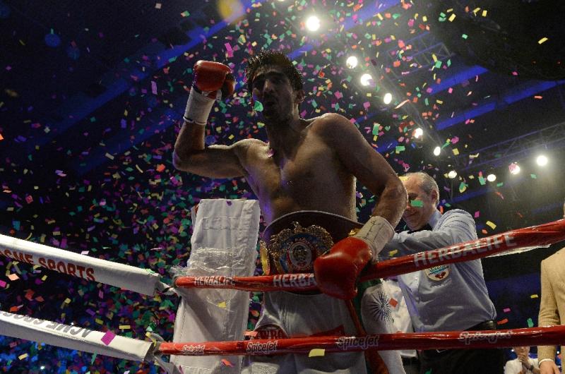 India's boxer Vijender Singh celebrates after defeating Australia's boxer Kerry Hope for the WBO Asia Pacific Super Middleweight title in New Delhi on July 16, 2016 (AFP Photo/Prakash Singh)