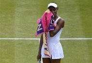 Venus Williams of the U.S. wipes her face during her women's singles tennis match against Elena Vesnina of Russia at the Wimbledon tennis championships in London June 25, 2012. REUTERS/Toby Melville