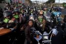 Eddie Villadelon, right, leader and organizer of the annual motorcycle pilgrimage to the church of the Black Christ of Esquipulas, leads the pilgrims as they leave Guatemala City, Saturday, Feb. 7, 2015. Pilgrims from all over Central America annually flock the city of Esquipulas to pay homage to a Black Christ located there. (AP Photo/Moises Castillo)