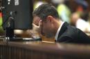 Oscar Pistorius places his hand over his face while sitting in the dock in court on the third day of his trial at the high court in Pretoria, South Africa, Wednesday, March 5, 2014. Pistorius is charged with murder for the shooting death of his girlfriend, Reeva Steenkamp, on Valentine's Day in 2013. (AP Photo/Alon Skuy, Pool)
