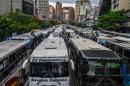 Employers of public transportation block a main avenue in Caracas during a protest due to the shortage in Venezuela of spare parts for their vehicles