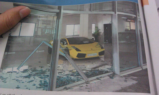 The scene of the EuroKars Pre-Owned showroom along Alexandra Road, where one of its door panels was shattered. (Yahoo! photo)