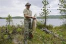 Russia's President Putin poses for a picture as he fishes in the Krasnoyarsk territory in the Siberian Federal District