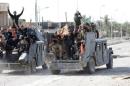 Iraqi counterterrorism forces gesture in Falluja