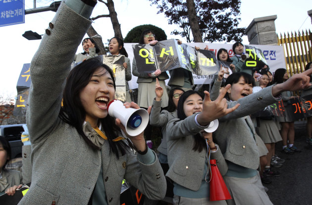 FILE - In this Nov. 7, 2013 file photo, South Korean students cheer their seniors' success in the Scholastic Aptitude Test in front of the main gate of an examination hall in Seoul, South Korea. Students from Shanghai, Hong Kong, Singapore, Taiwan, Japan and South Korea were among the highest-ranking groups in math, science and reading in test results released Tuesday, Dec. 3, 2013 by the Program for International Student Assessment (PISA) coordinated by the Paris-based Organization for Economic Cooperation and Development (OECD). The group tests students worldwide every three years. (AP Photo/Ahn Young-joon, File)