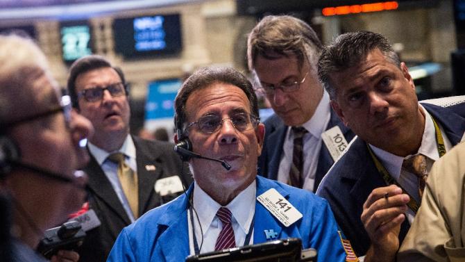 Traders work on the floor of the New York Stock Exchange during the morning of August 27, 2015