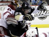 Pittsburgh Penguins' Matt Cooke (24) collides with Phoenix Coyotes goalie Mike Smith (41) after colliding with Coyotes' Antoine Vermette (50) in the second period of an NHL hockey game in Pittsburgh, Monday, March 5, 2012. (AP Photo/Gene J. Puskar)