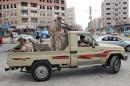 Yemeni army soldiers patrol a street in Mansoura district of Yemen's southern port city of Aden