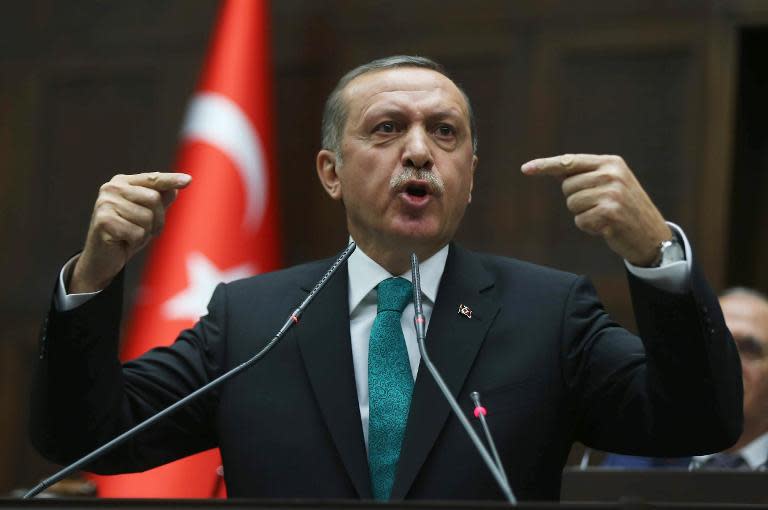 -Turkish Prime Minister Recep Tayyip Erdogan delivers a parliamentary speech to lawmakers in Ankara, on January 14, 2014
