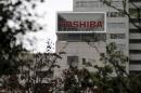 The logo of Toshiba Corp is seen behind trees at its headquarters in Tokyo