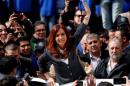 Former Argentine President Fernandez de Kirchner waves to supporters as she leaves a Justice building
