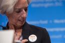 International Monetary Fund Managing Director Christine Lagarde points to a badge reading "Isolate Ebola Not Countries" during the annual IMF/World Bank meetings in Washington on October 11, 2014