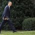 President Barack Obama looks to the media as he walks to the Oval Office of the White House as he returns from greeting members of the staff, Tuesday, Dec. 18, 2012, in Washington. (AP Photo/Carolyn Kaster)