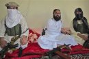 Wali-ur-Rehman, deputy Pakistani Taliban leader, who is flanked by militants speaks to a group of reporters in Shawal town