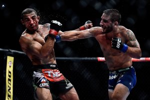 Chad Mendes, right, punches Jose Aldo during their second fight on Oct. 25, 2014. (Getty Images)