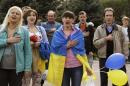 People sing Ukranian national anthem as they attend a pro-Ukrainian rally in Luhansk