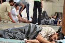 A survivor from what activists say is a gas attack rests inside a mosque in the Duma neighbourhood of Damascus