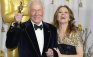 Christopher Plummer, holds his Oscar for best supporting actor for his role in "Beginners" with presenter Melissa Leo backstage at the 84th Academy Awards in Hollywood, California