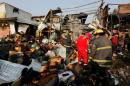 Firemen gather at the site of a car bomb attack at a vegetable market in eastern Baghdad