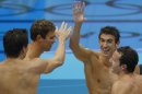 Michael Phelps, second from right, celebrates with members of the gold medal men's 4 X 100-meter medley relay team at the Aquatics Centre in the Olympic Park during the 2012 Summer Olympics in London, Saturday, Aug. 4, 2012. (AP Photo/Julio Cortez)