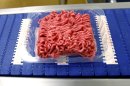 Ground beef is seen on a conveyor belt at the Fresh & Easy Neighborhood Market meat processing facility in Riverside