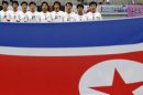 North Korea's national soccer team players sing their national anthem before the Women's East Asian Cup soccer championship match against South Korea at the Seoul World Cup stadium in Seoul