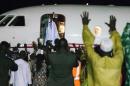 Former president Yaya Jammeh (C), the Gambia's leader for 22 years, waves from the plane as he leaves the country on 21 January 2017 in Banjul
