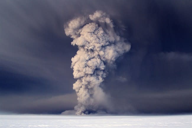 In this photo taken on Saturday, May 21, 2011, smoke plumes from the Grimsvotn volcano, which lies under the Vatnajokull glacier, about 120 miles, (200 kilometers) east of the capital, Rejkjavik, which began erupting Saturday for the first time since 2004. Iceland closed its main international airport and canceled domestic flights Sunday as a powerful volcanic eruption sent a plume of ash, smoke and steam 12 miles (20 kilometers) into the air. (AP Photo, Jon Gustafsson) ICELAND OUT
