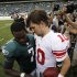 Philadelphia Eagles' Michael Vick, left, shows his hand to New York Giants' Eli Manning after an NFL football game on Sunday, Sept. 25, 2011, in Philadelphia. Vick left with a broken right hand in the fourth quarter and New York won 29-16. (AP Photo/Matt Slocum)