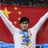 China's Sun Yang raises his national flag after winning the gold medal in the men's 800 m Freestyle at the FINA 2011 Swimming World Championships in Shanghai, China, Wednesday, July 27, 2011. (AP Photo/Eugene Hoshiko)