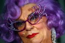 FILE -In this Aug. 25, 2004 file photo Australian actor Barry Humphries, dressed as Dame Edna Everage, appears at a press conference in San Francisco, USA. Dame Edna Everage, the Tony Award-winning drag act known for her purple hair and oversized rhinestone eyeglasses, will soon open her final stage show tour in Australia. (AP Photo/Marcio Jose Sanchez, File)